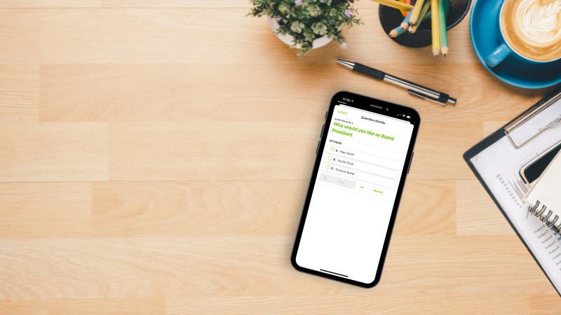 light wood desktop with office supplies and phone