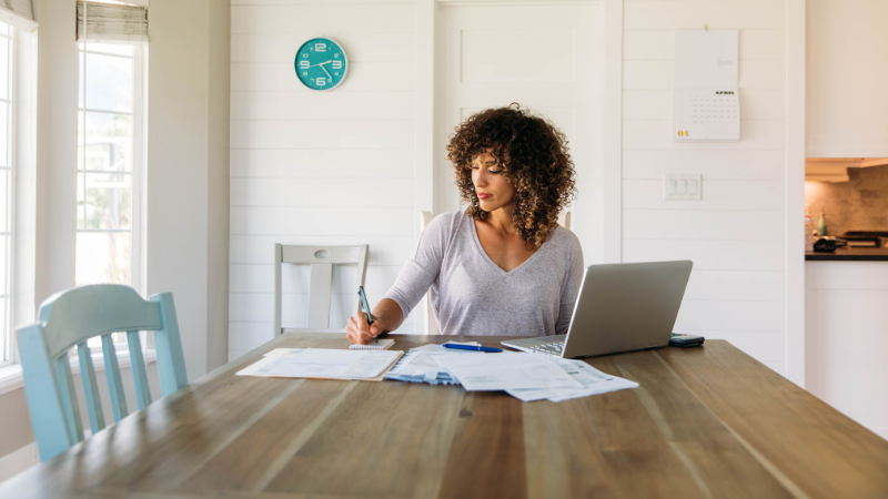 mixed race woman doing calculations
