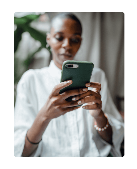 Black woman using green cellphone