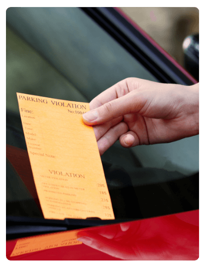 a red car getting a parking violation ticket