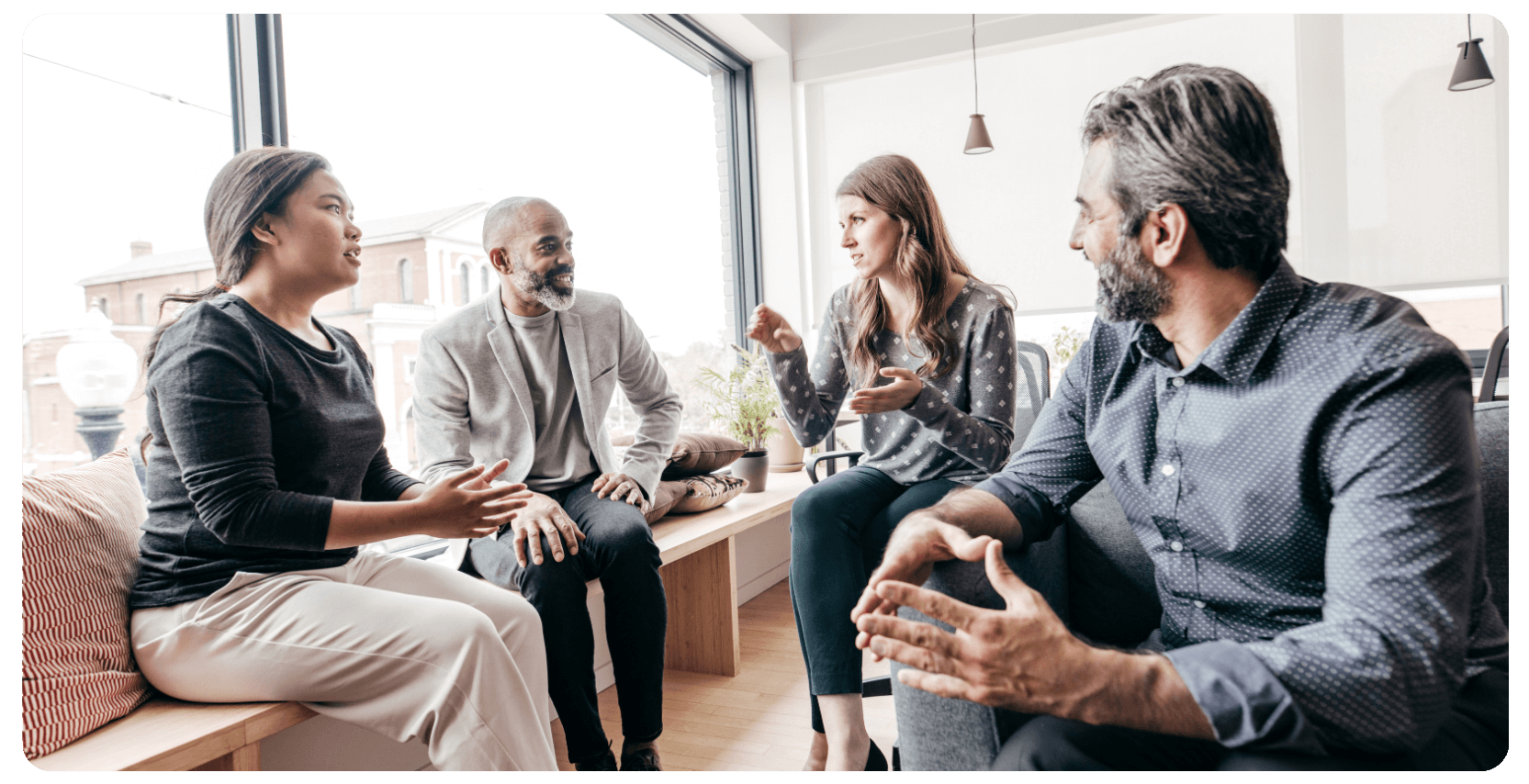 a group of four business people having a casual business meeting