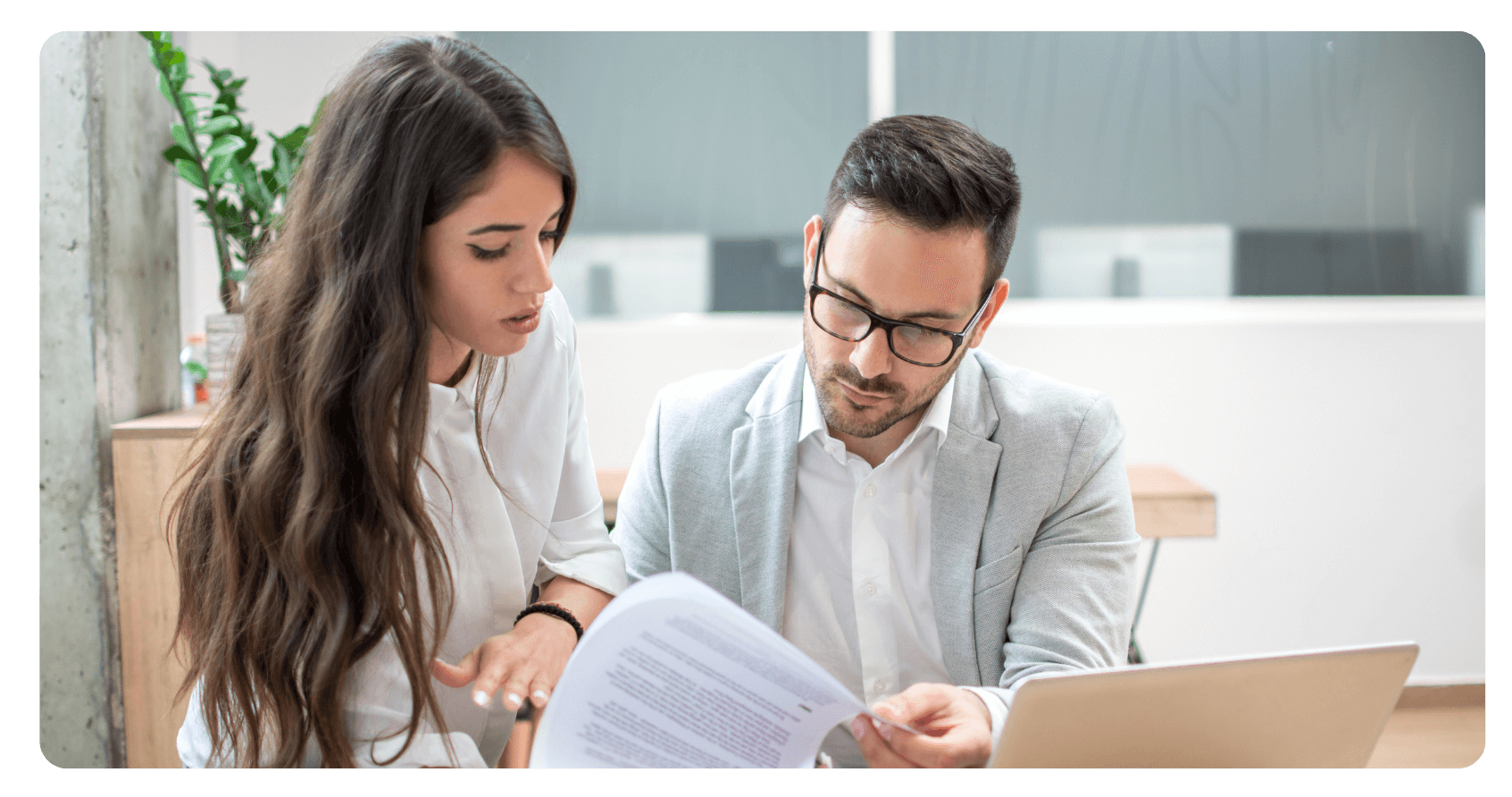 a business man and woman looking over paperwork