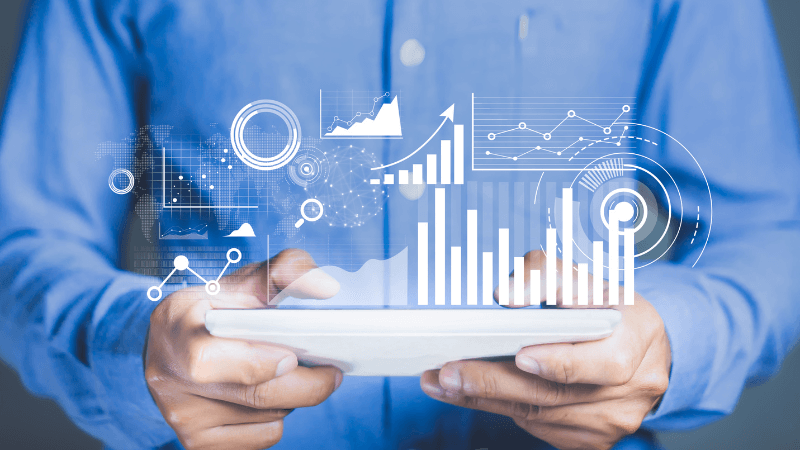 white man holding an iPad with technology data symbols