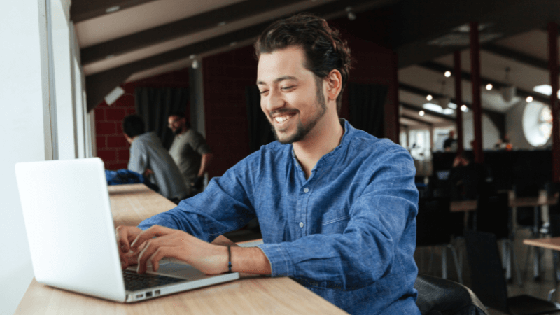 man in a coffee shop using a computer
