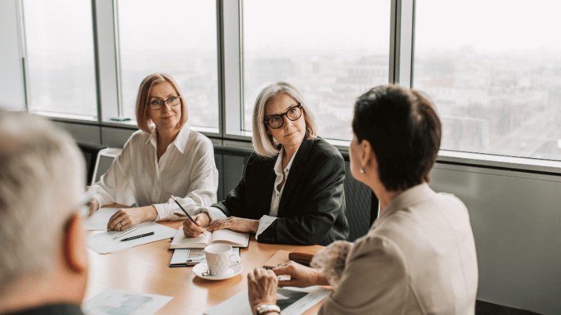three women in a boardroom