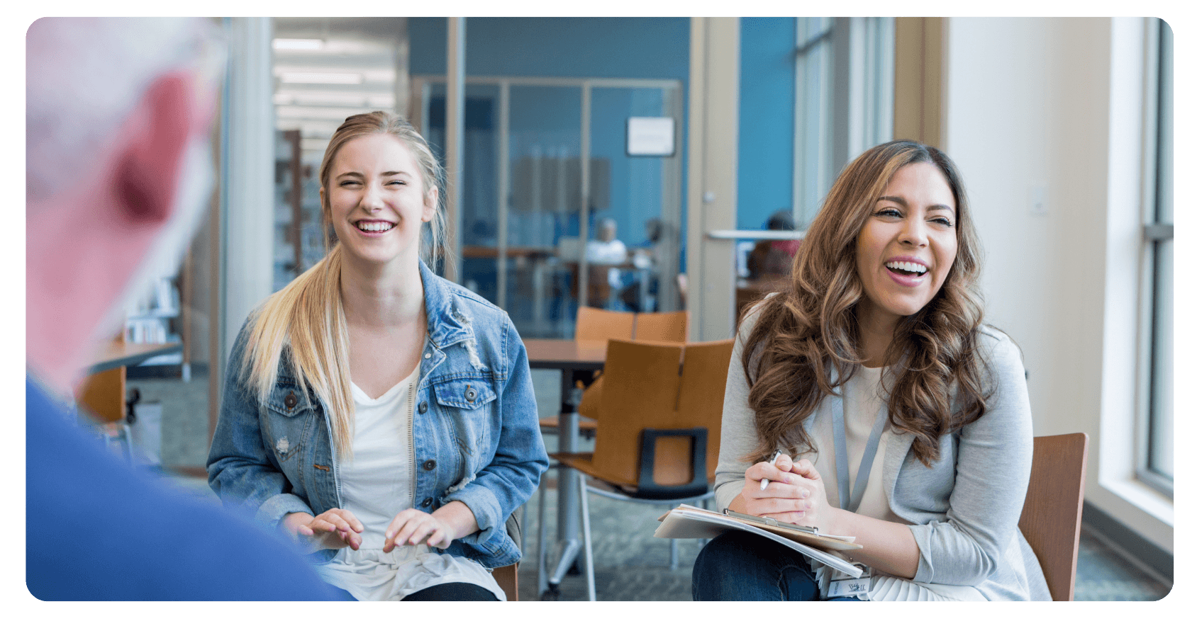 two women in a room laughing