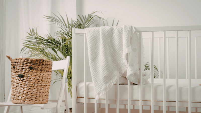 white baby crib in a white room