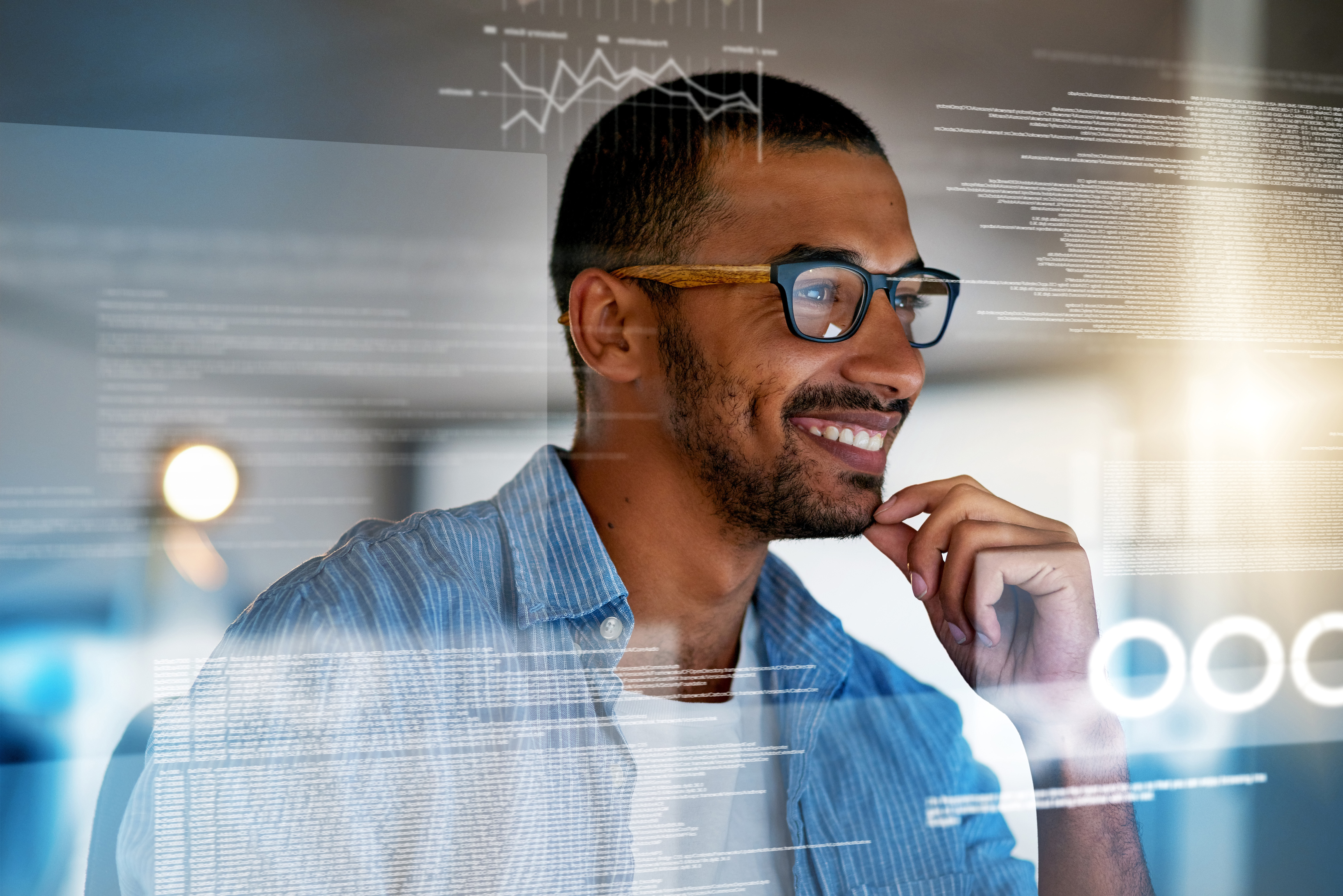 Younger man with glasses looking through a transparent screen at his HOA software