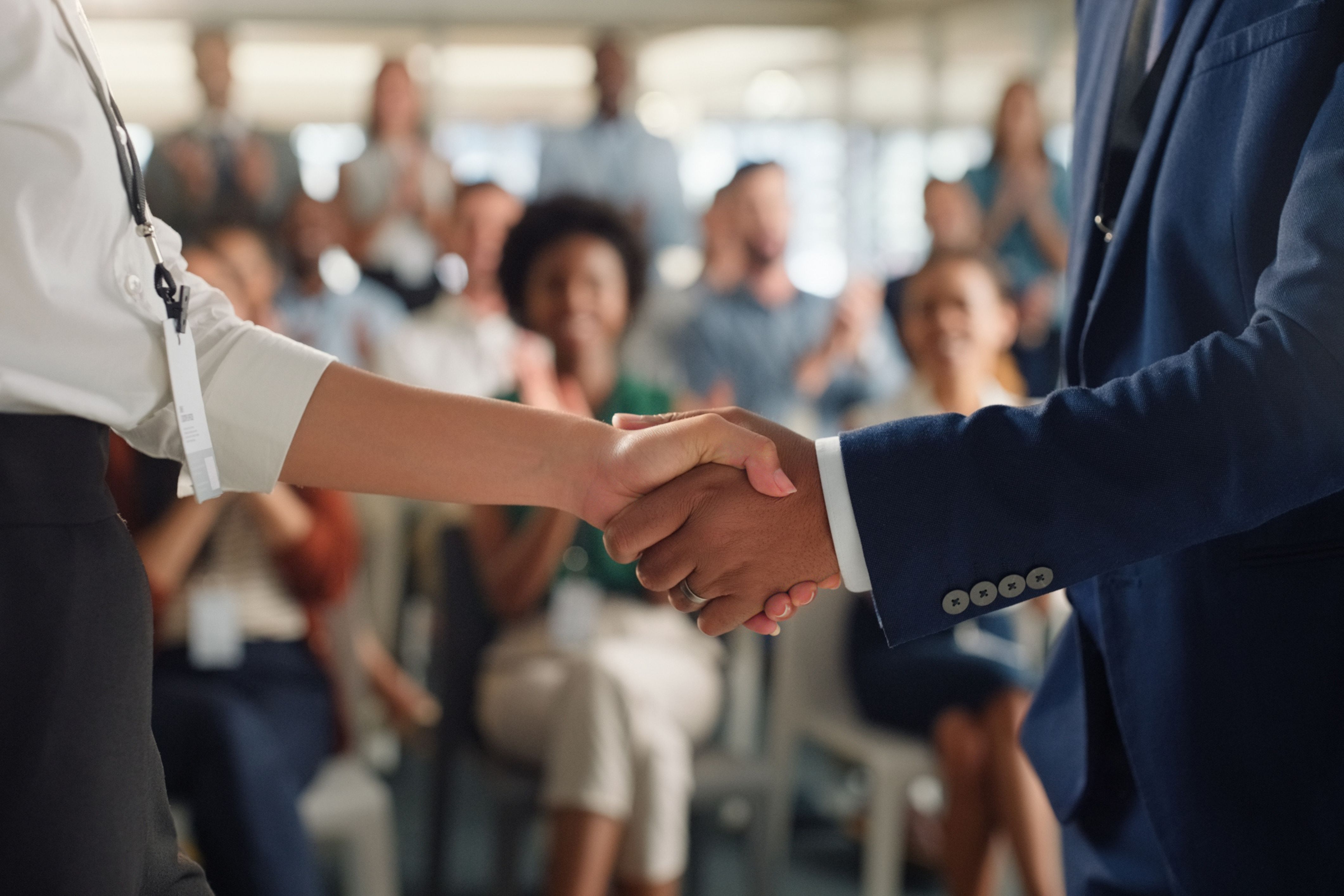 Hands shaking to represent TownSq introducing community management app at South by Southwest