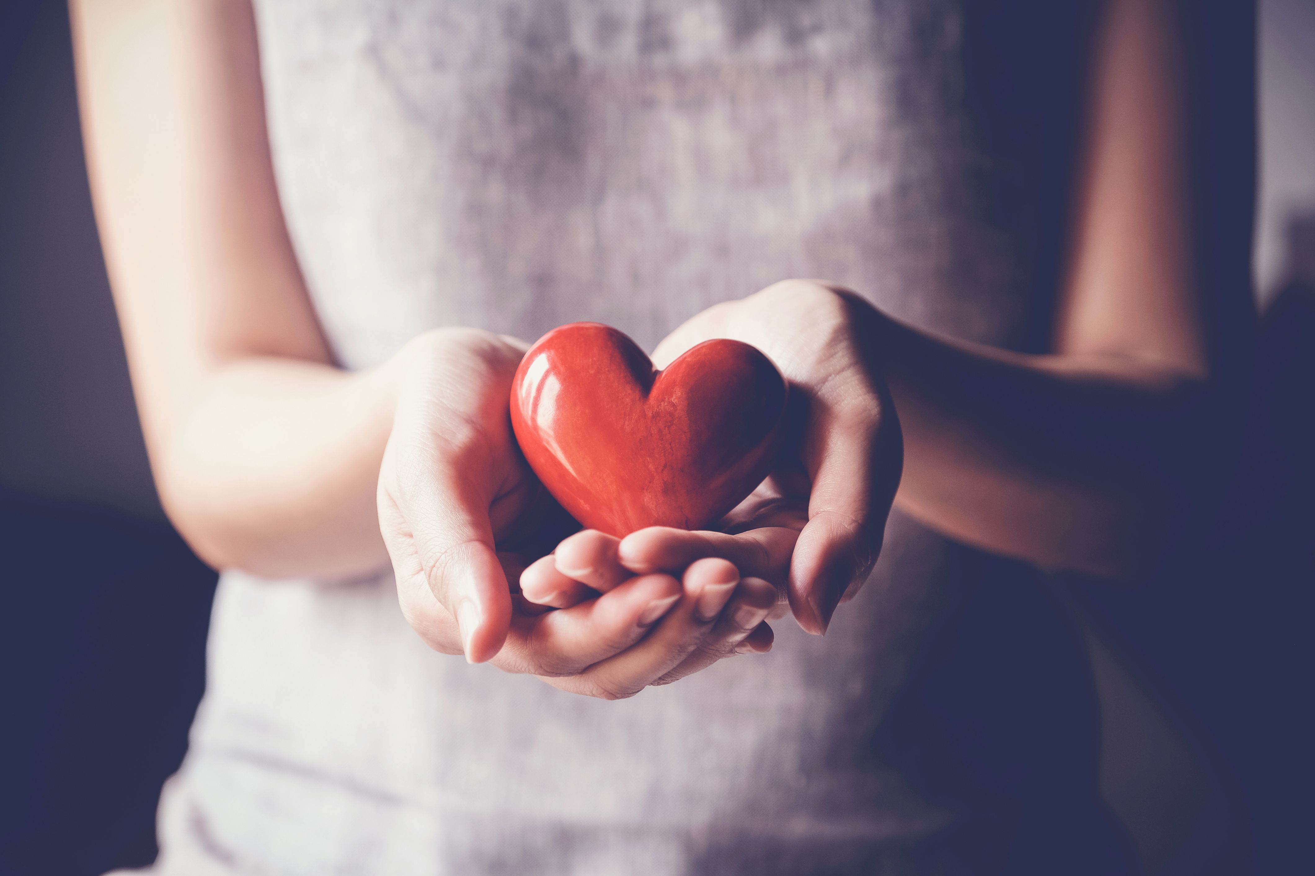 A person holds out a stone heart, representing making an overnight guest feel comfortable.