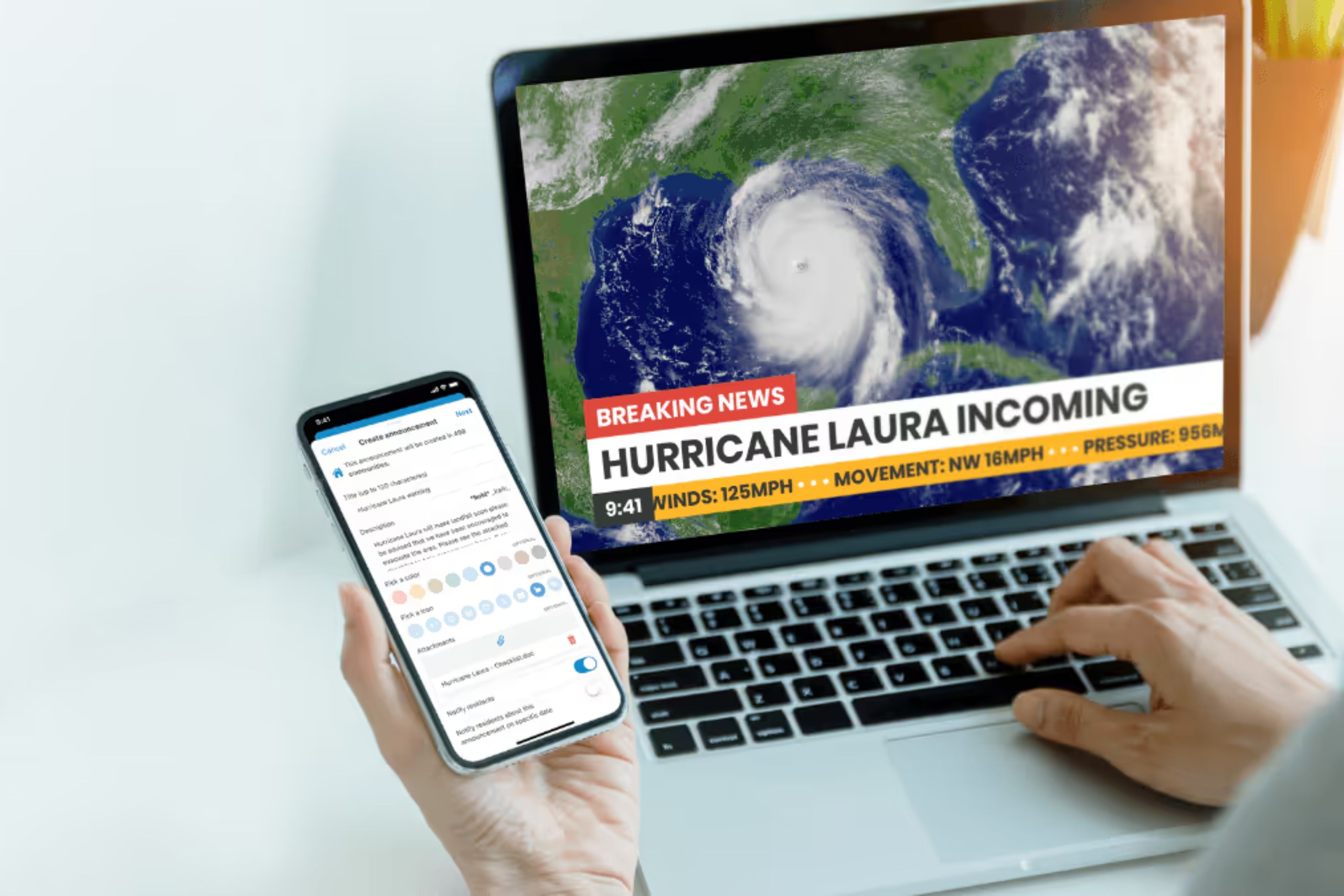 A person looks at their phone and computer to see global announcements from TownSq.