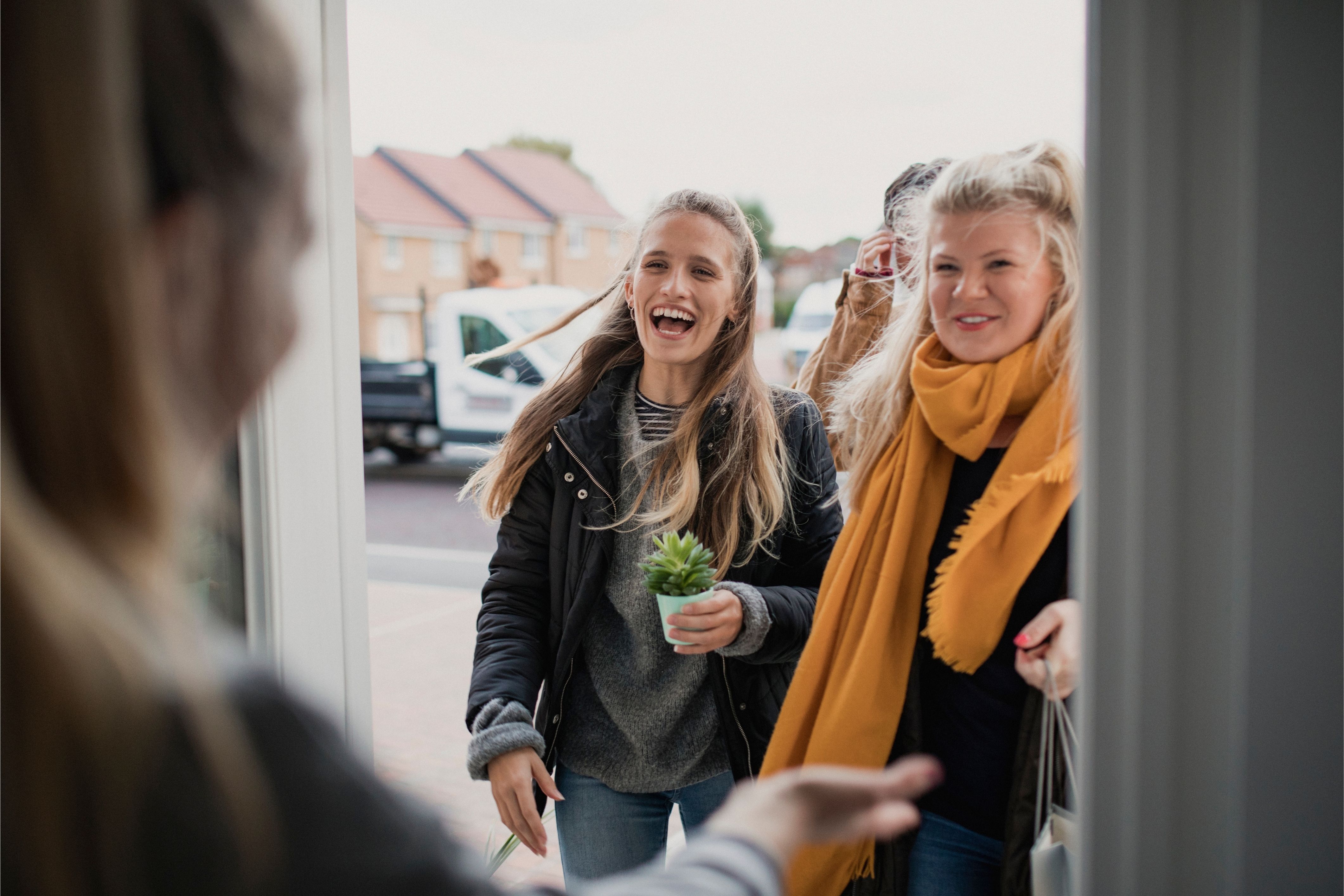 Happy neighbors come to the door in an HOA community.