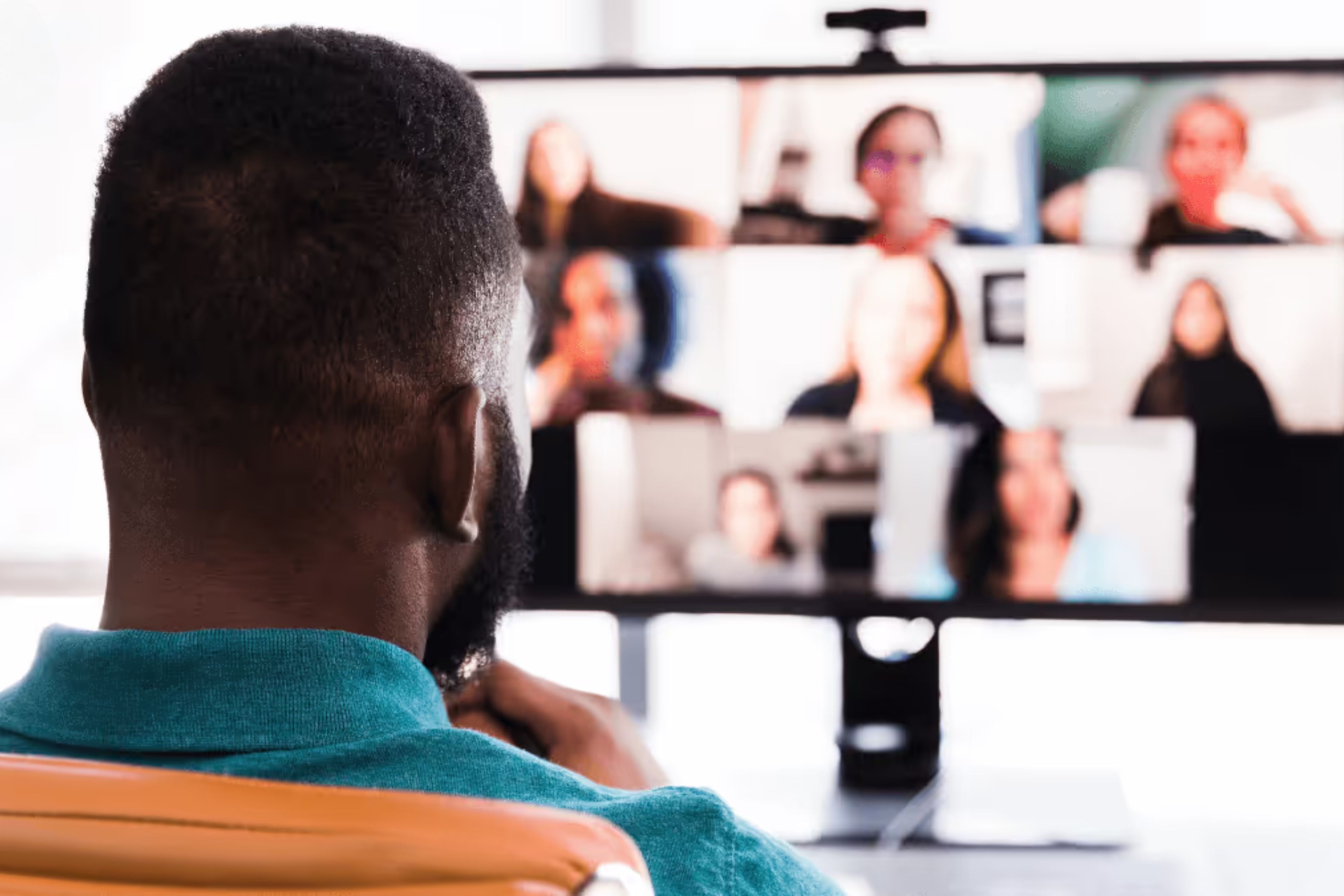A man sits at his computer running an effective online HOA board meeting.