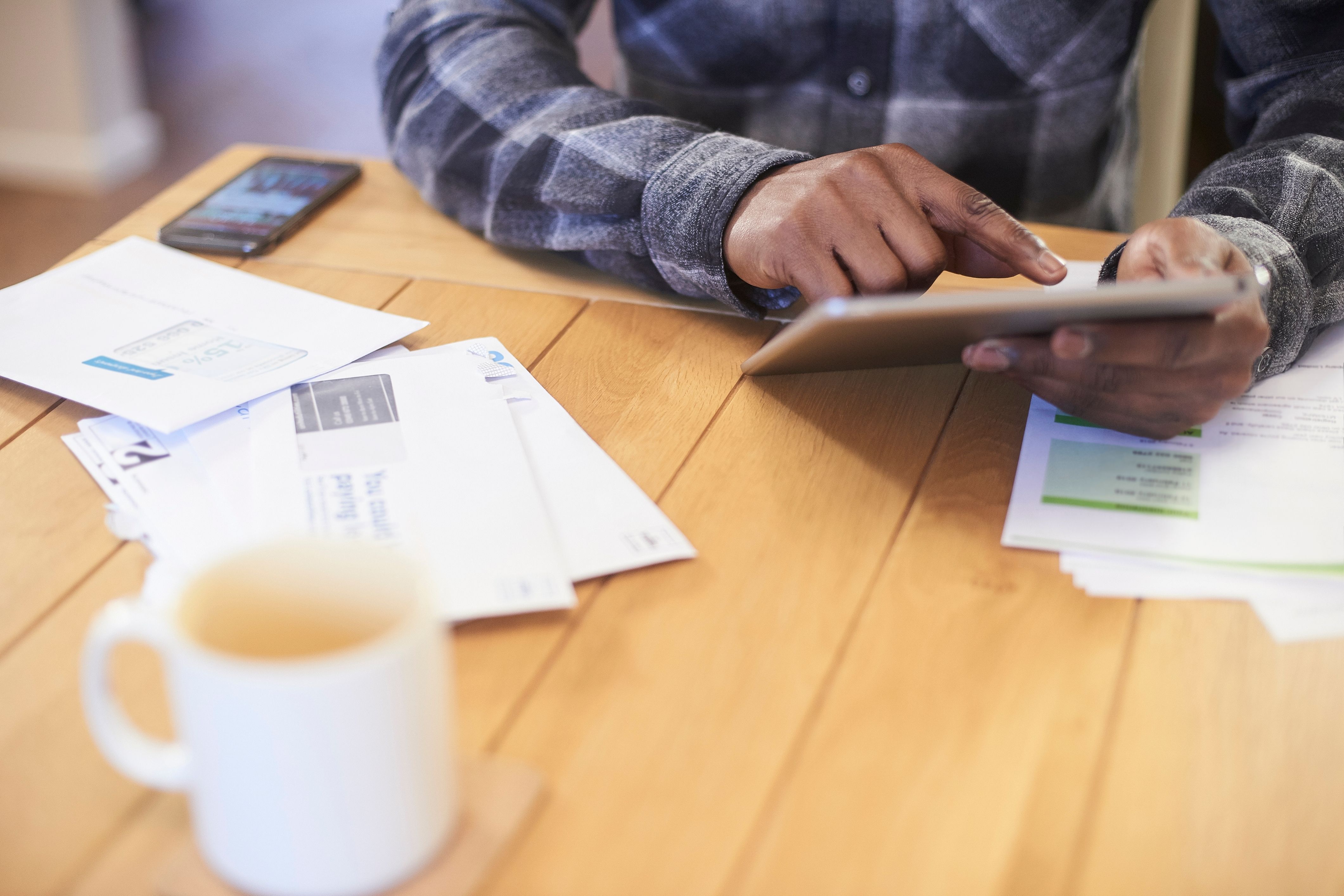 A man sits at a table managing the financial health of his HOA community.