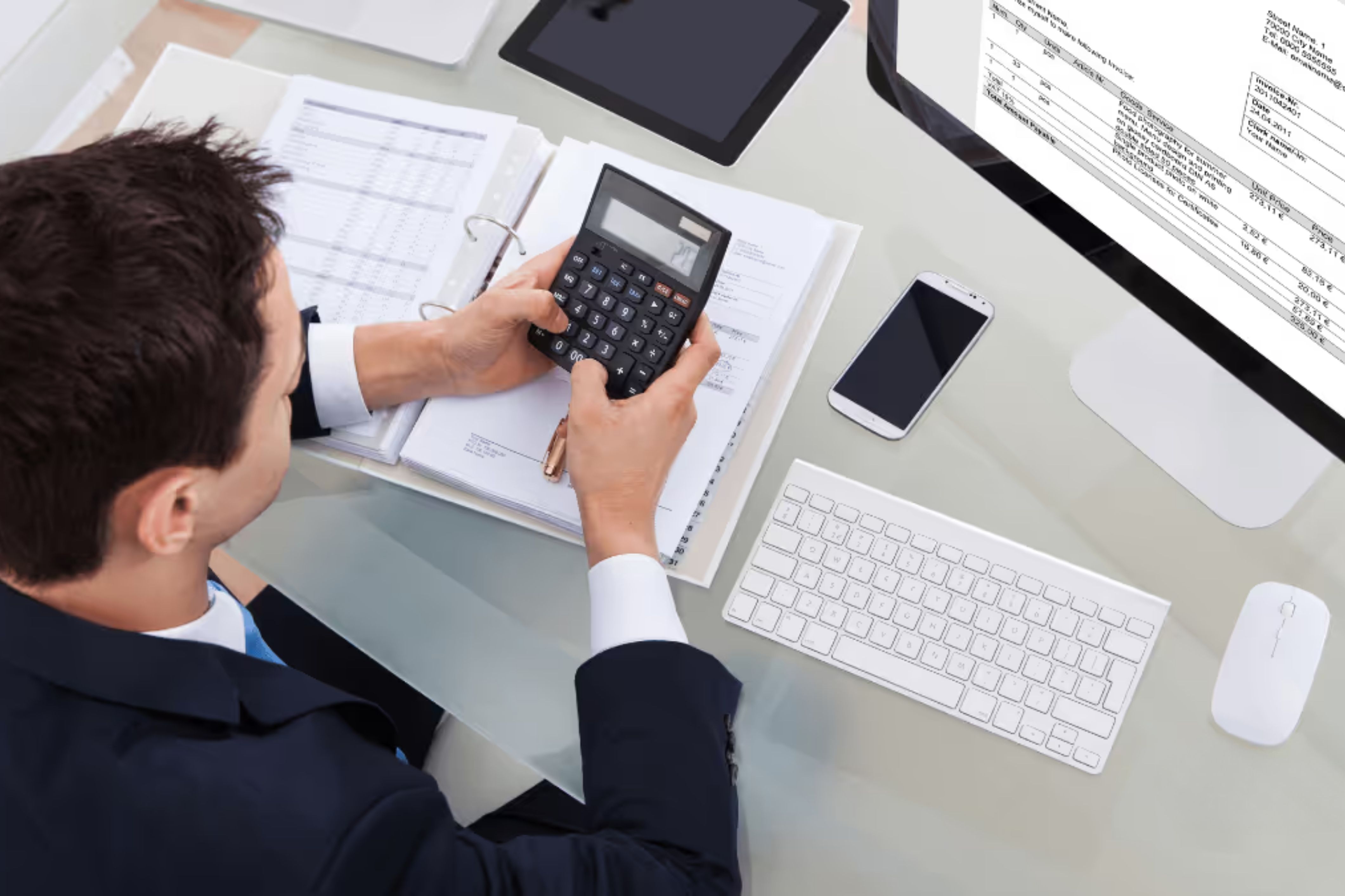 An HOA community manager sits at his computer preparing an HOA tax return.