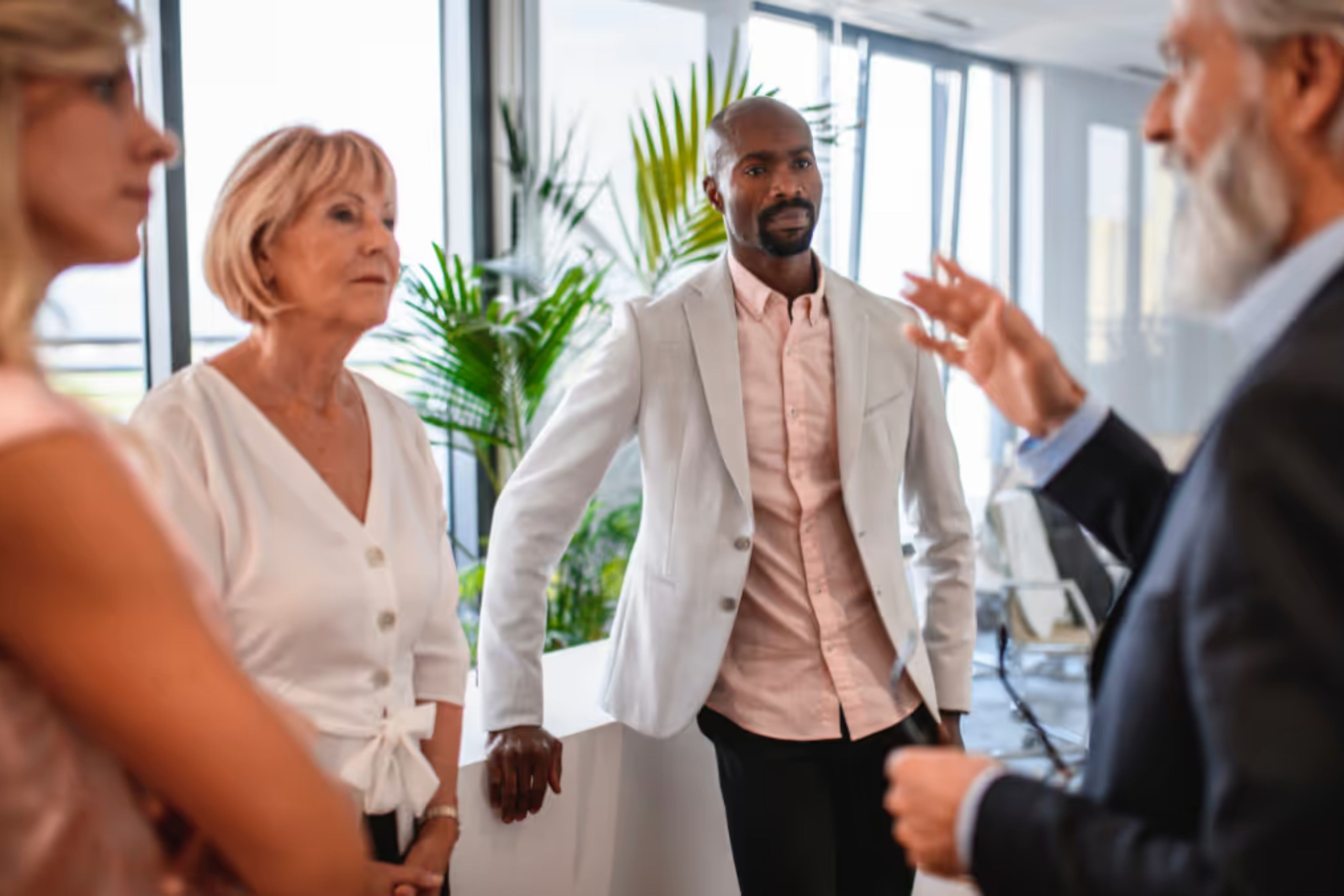 Several property managers stand in a circle exercising strong communication with one another.