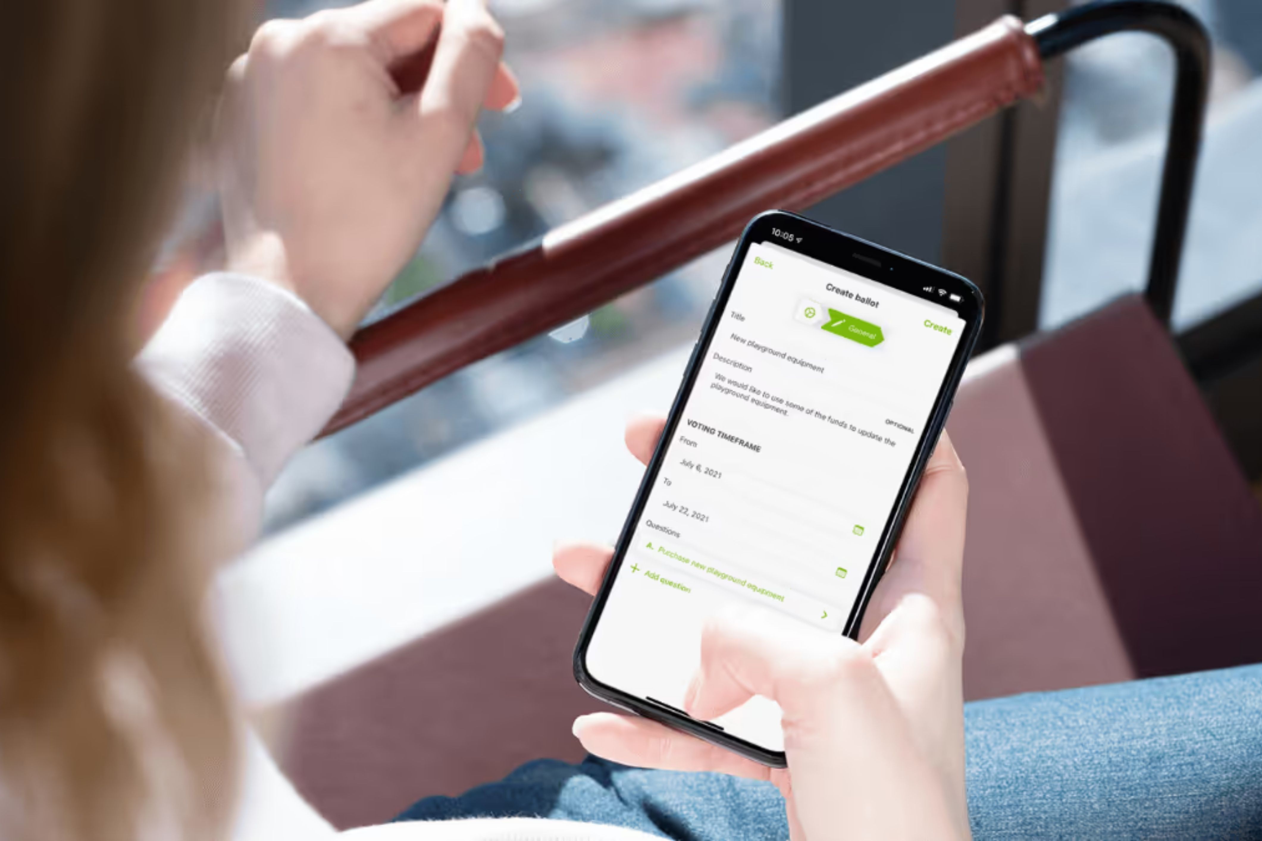 An HOA community member looks at TownSq's new voting feature on her phone.