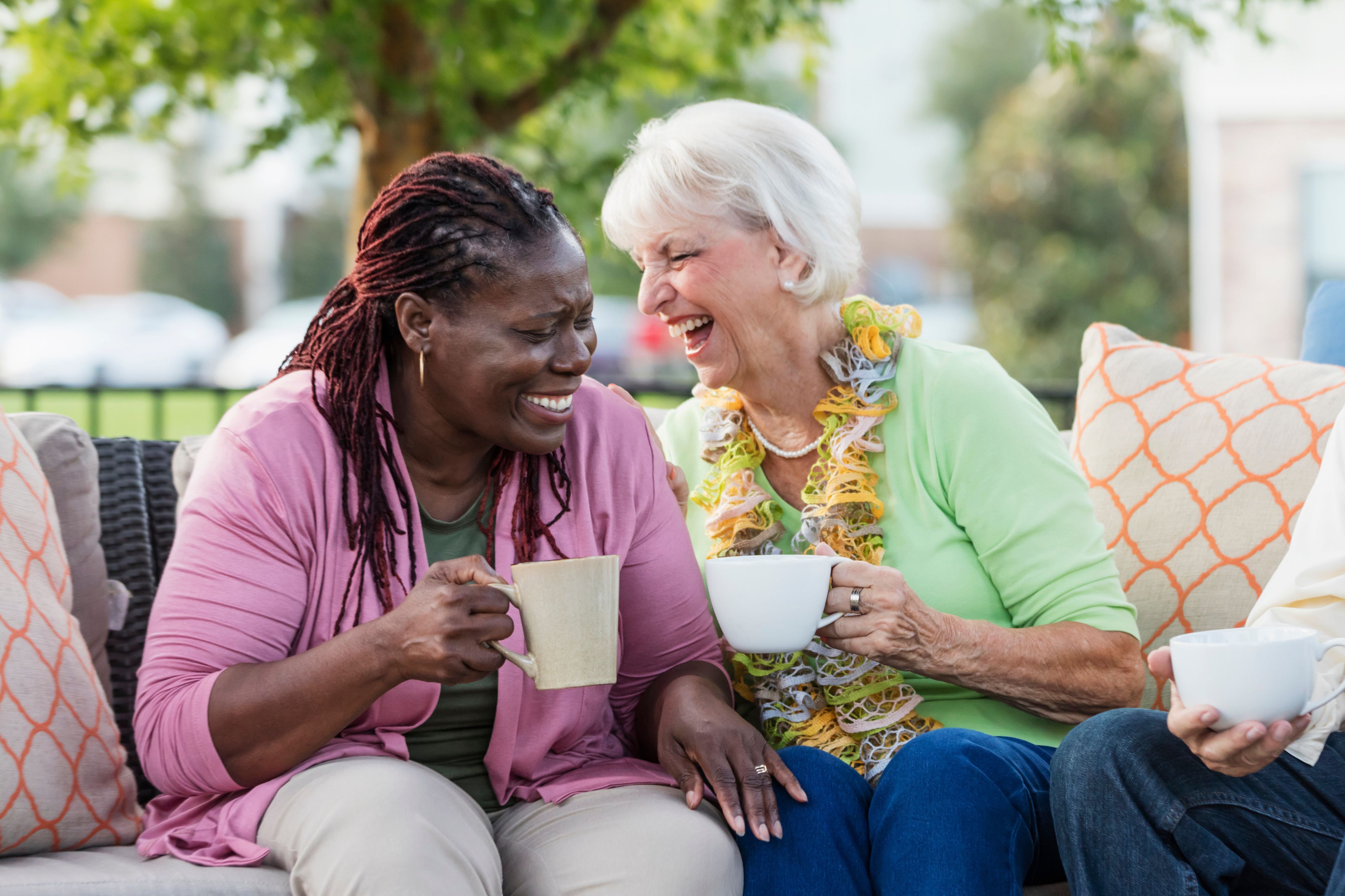 Two neighbors in an HOA community chant and laugh with one another.