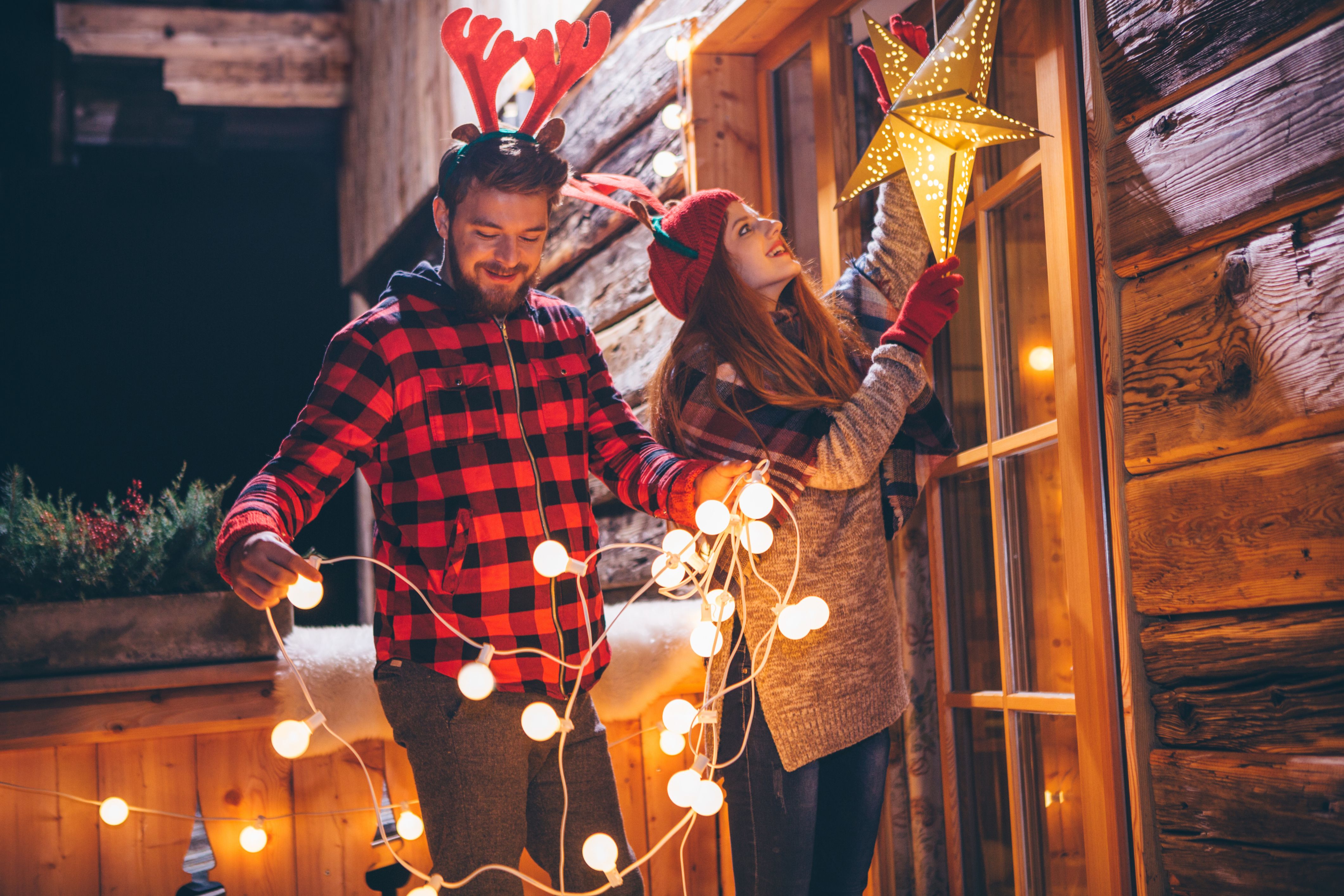 Two HOA community members put up holiday decor on their house.