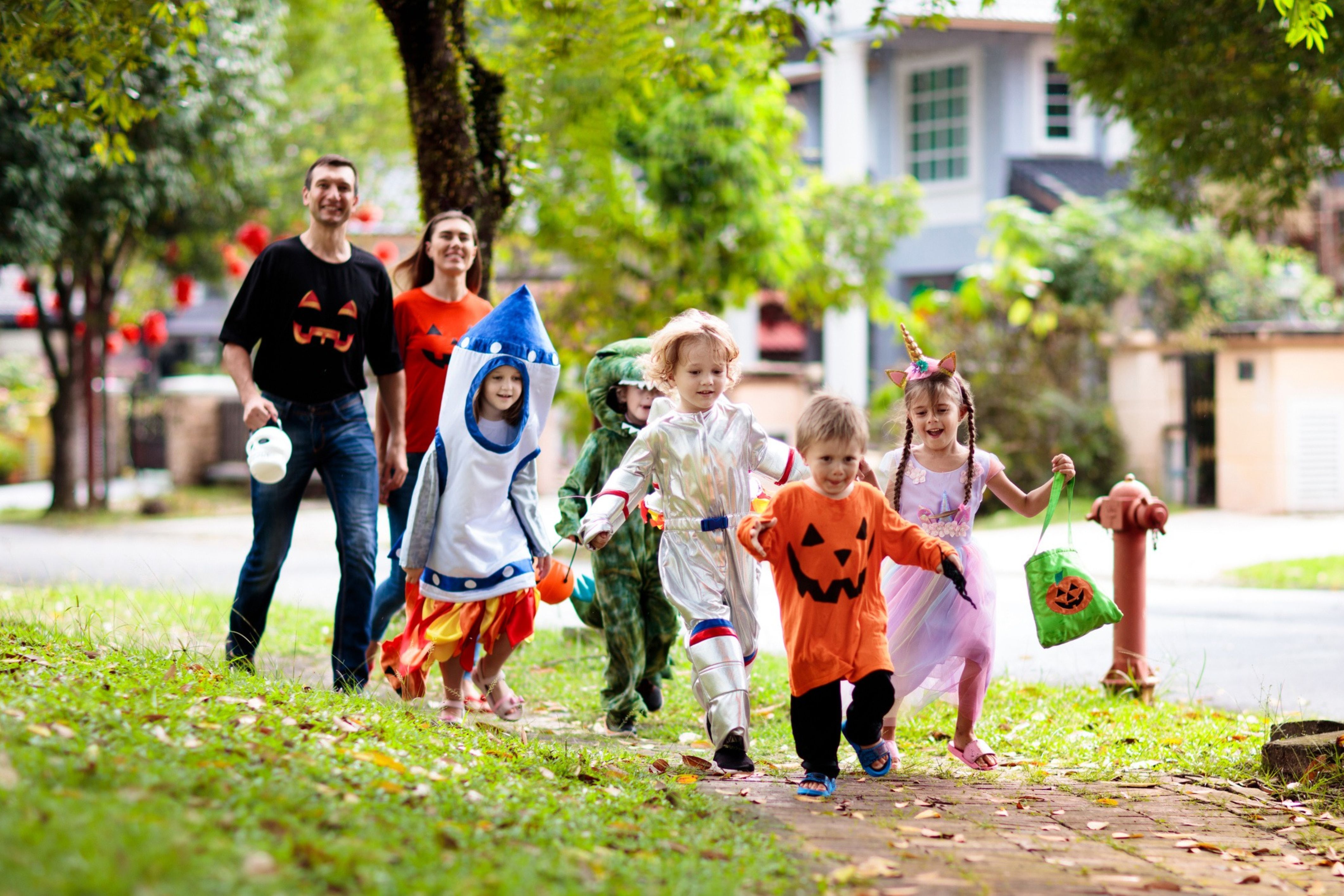 Families in an HOA community engage in trick-or-treating on Halloween.