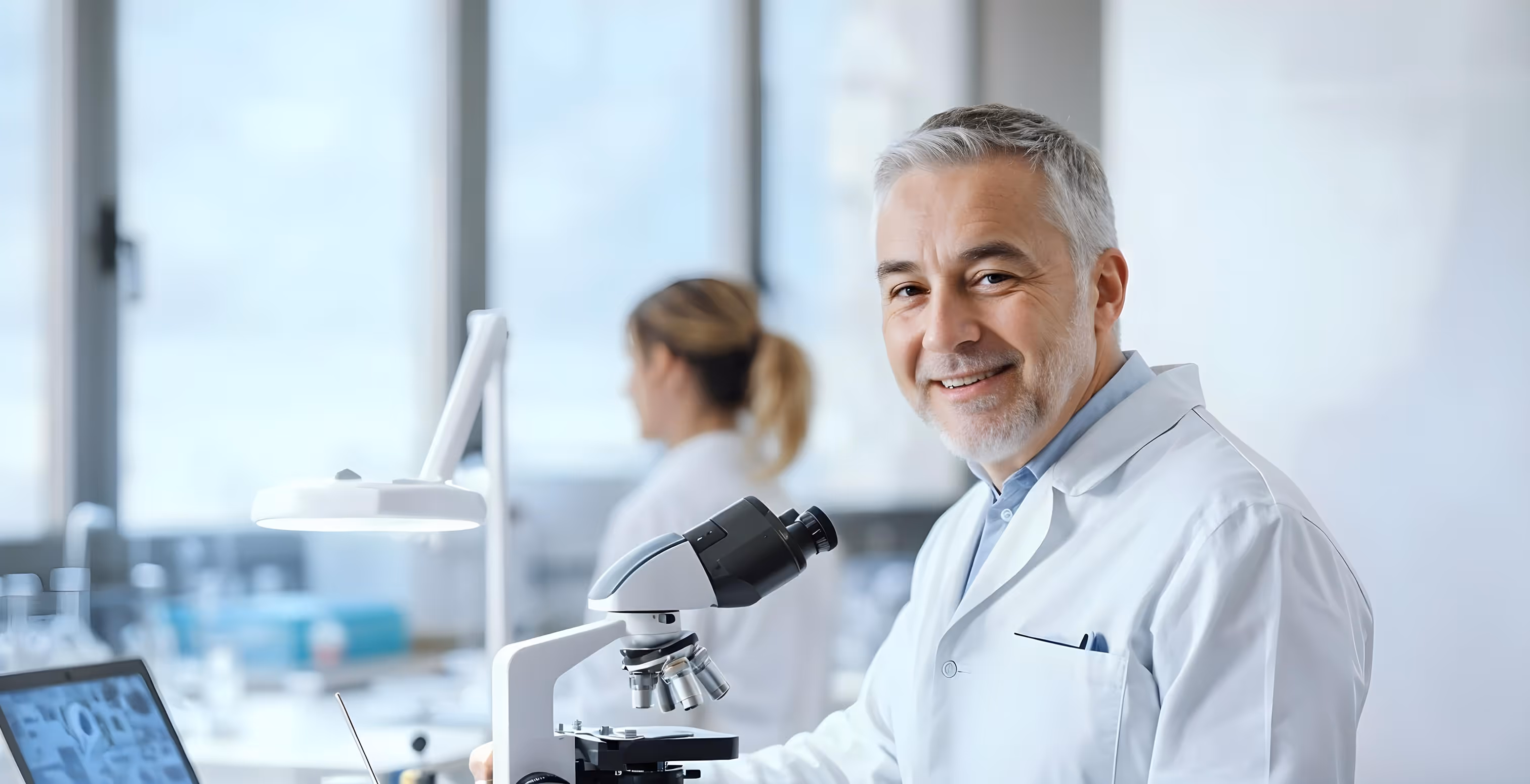Doctor with stethoscope consulting with patient at desk in medical office
