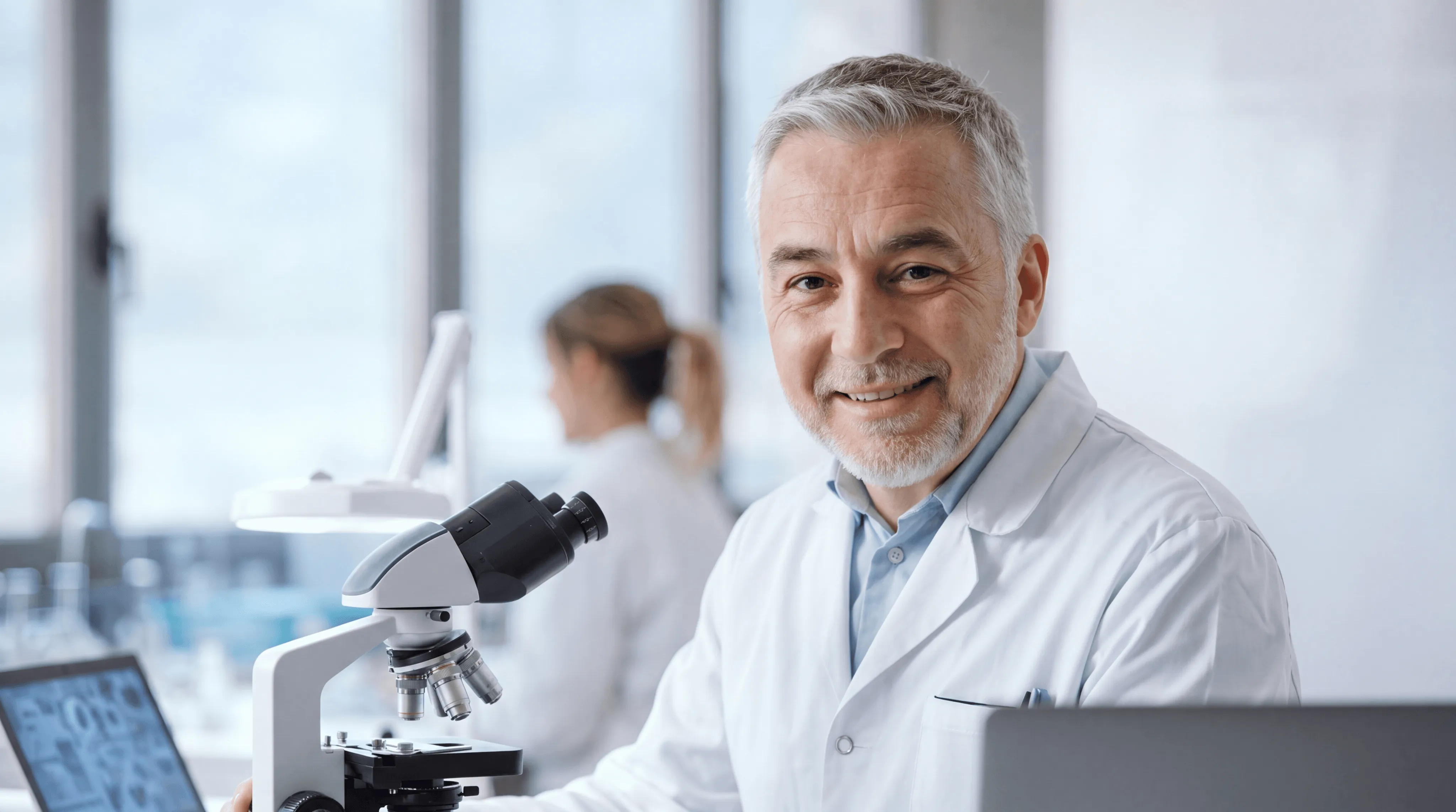 Doctor with stethoscope consulting with patient at desk in medical office
