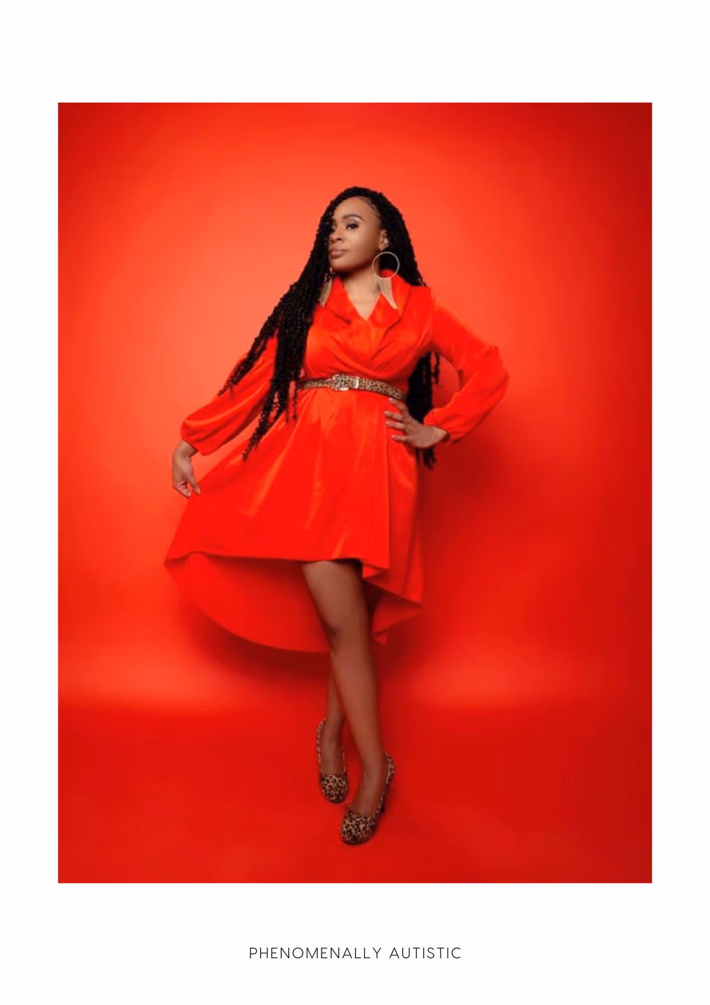 Photo of Ayanna Davis, a young attractive black woman, posing in a red dress. Her hair is in long braids, she is wearing earrings, leopard print shoes. One leg is crossed over the other.The backdrop is red. Text reads: Phenomenally Autistic