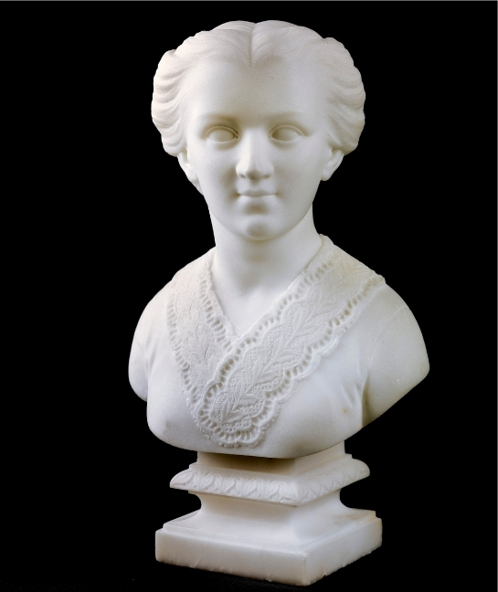 White marble portrait bust by Edmonia Lewis of a young woman with softly parted hair and a finely carved lace collar.