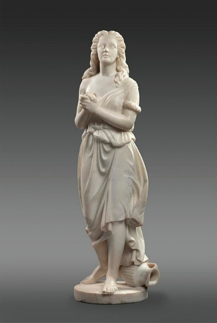 White marble sculpture by Edmonia Lewis of the biblical figure Hagar, standing with her hands clasped at her chest and her face lifted upward.