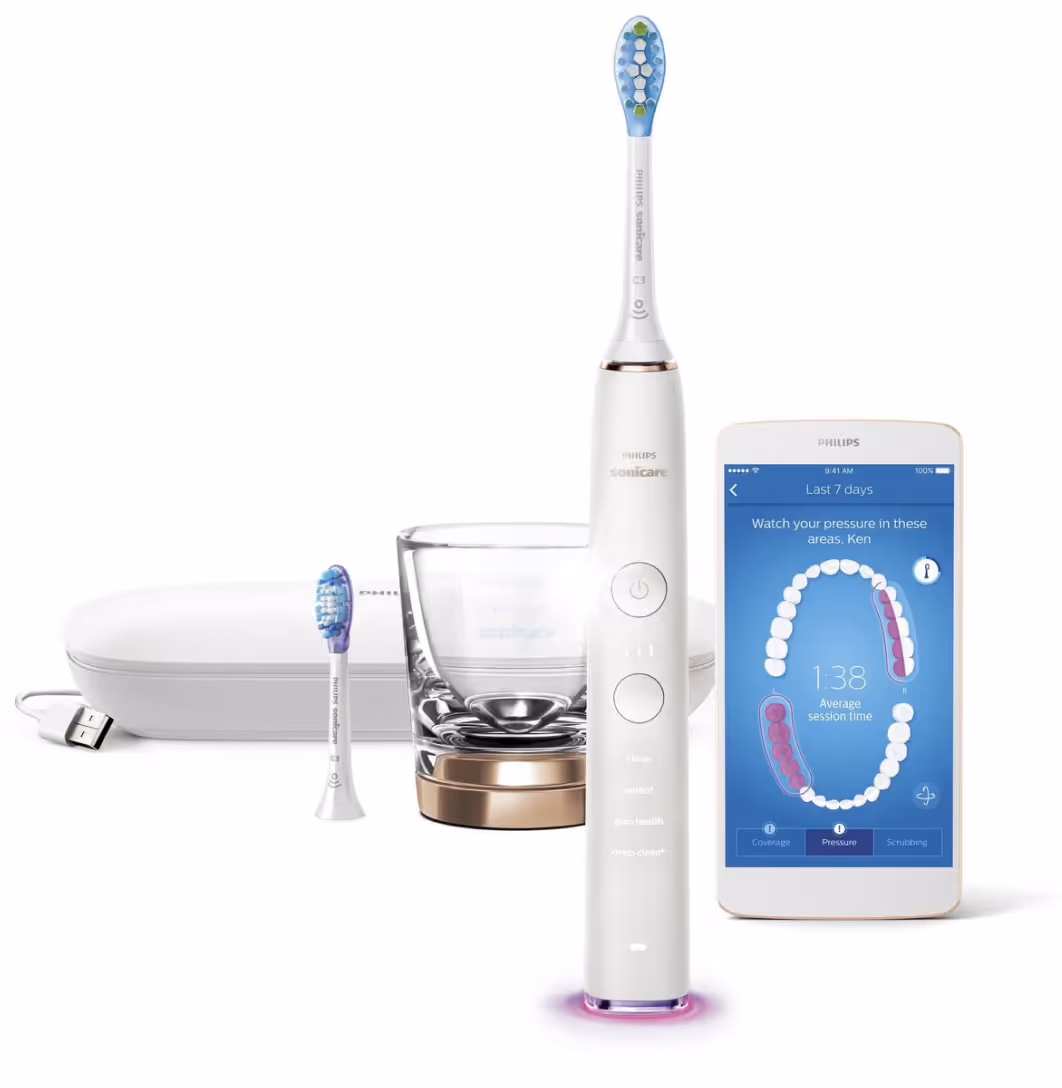 Philips Sonicare electric toothbrush with extra head, charging glass, and app showing brushing pressure areas.