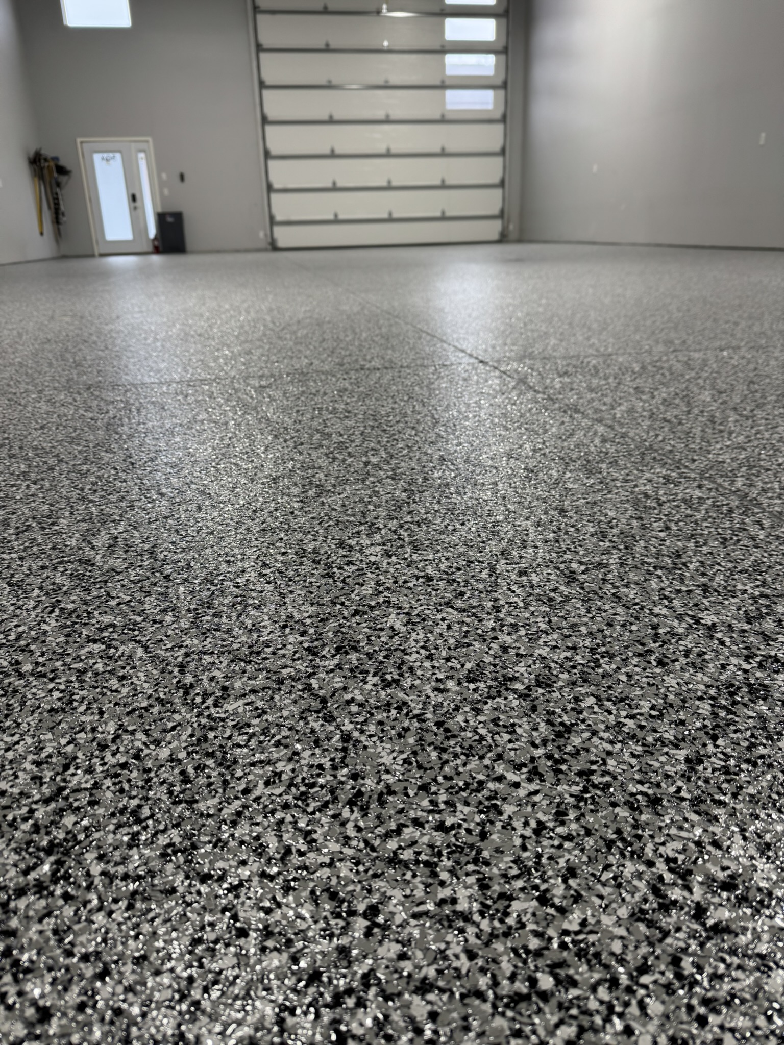 Metallic epoxy flooring in finished residential basement Bismarck ND
