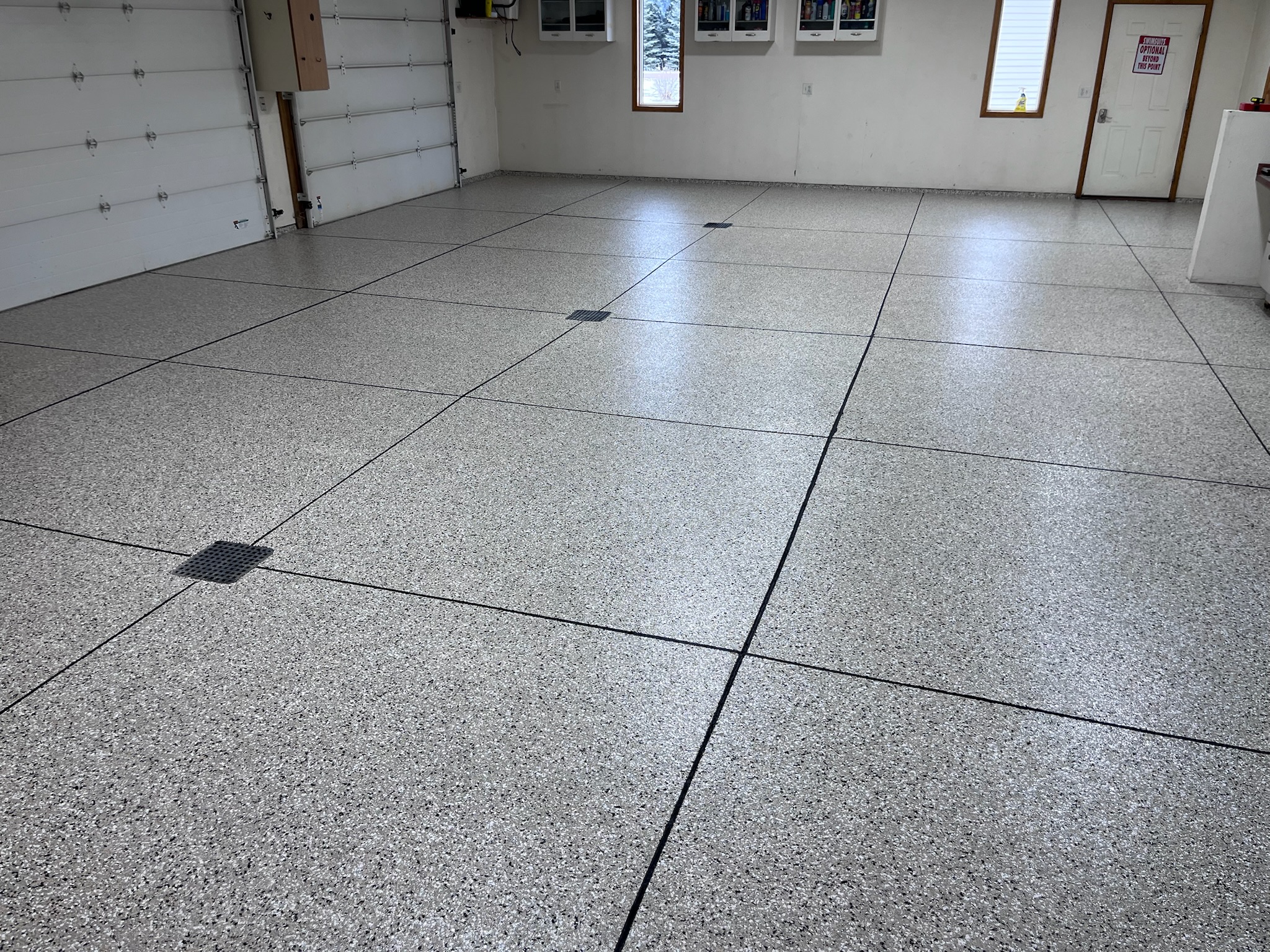 Metallic epoxy flooring in finished residential basement Bismarck ND