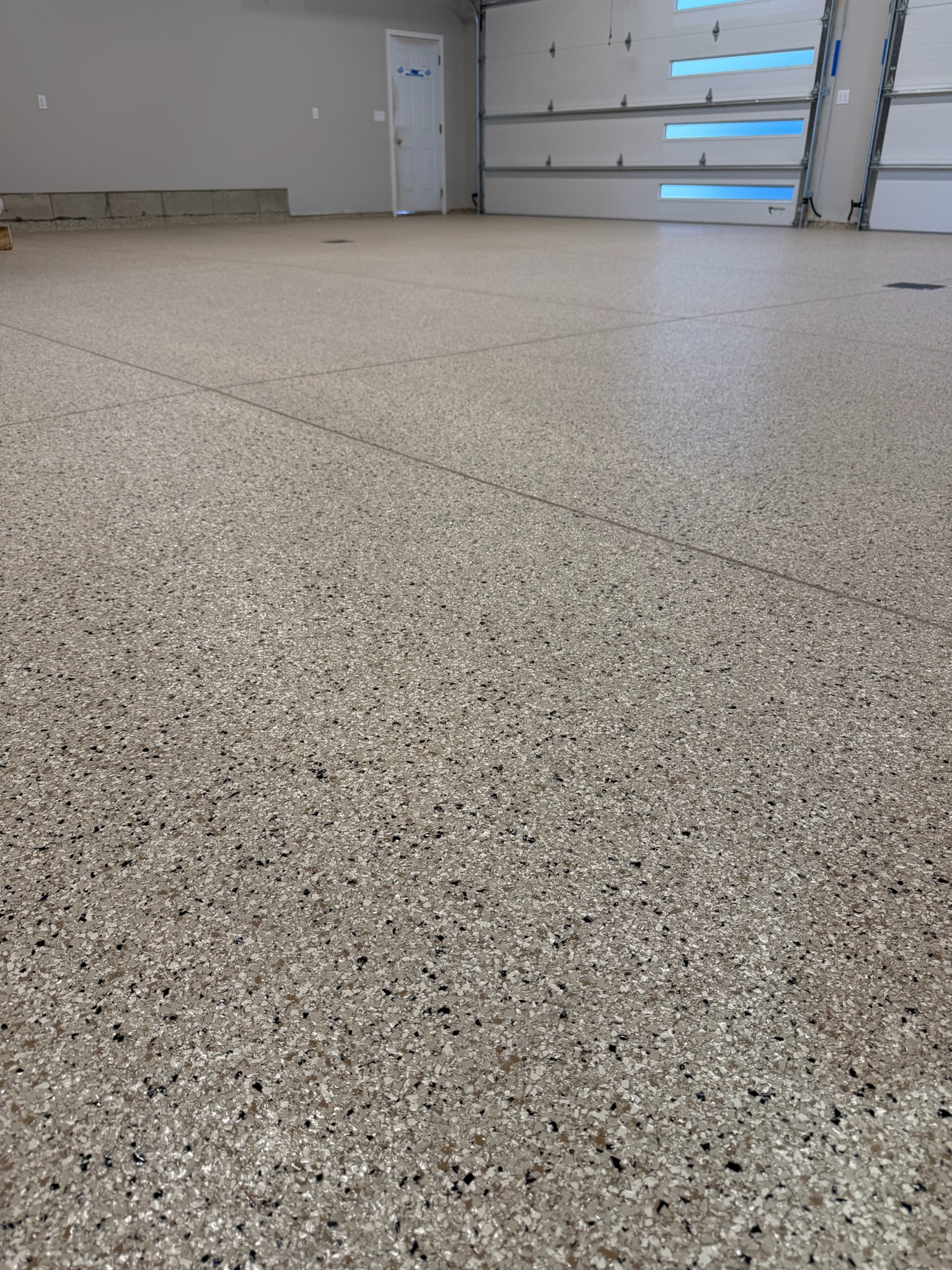 Gray flake epoxy flooring in finished residential garage Bismarck ND