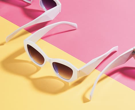 Stylish sunglasses on a colorful background