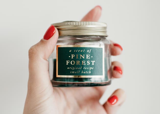 Hand holding a small ‘Pine Forest’ jar.