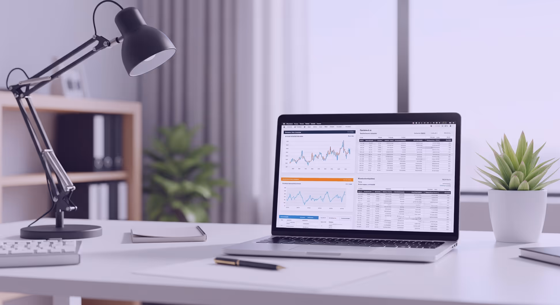 Employé tapant sur un ordinateur portable affichant des tableaux financiers, bureau minimaliste et lumineux.