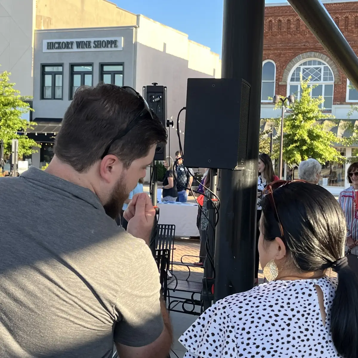 RYGID AV technician planning AV strategy with client at outdoor community event in downtown Hickory, NC
