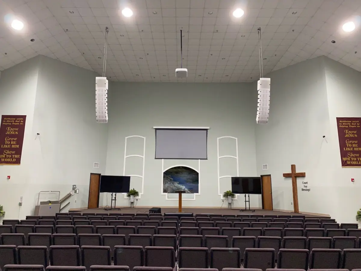 Church sanctuary with line array speakers suspended from ceiling