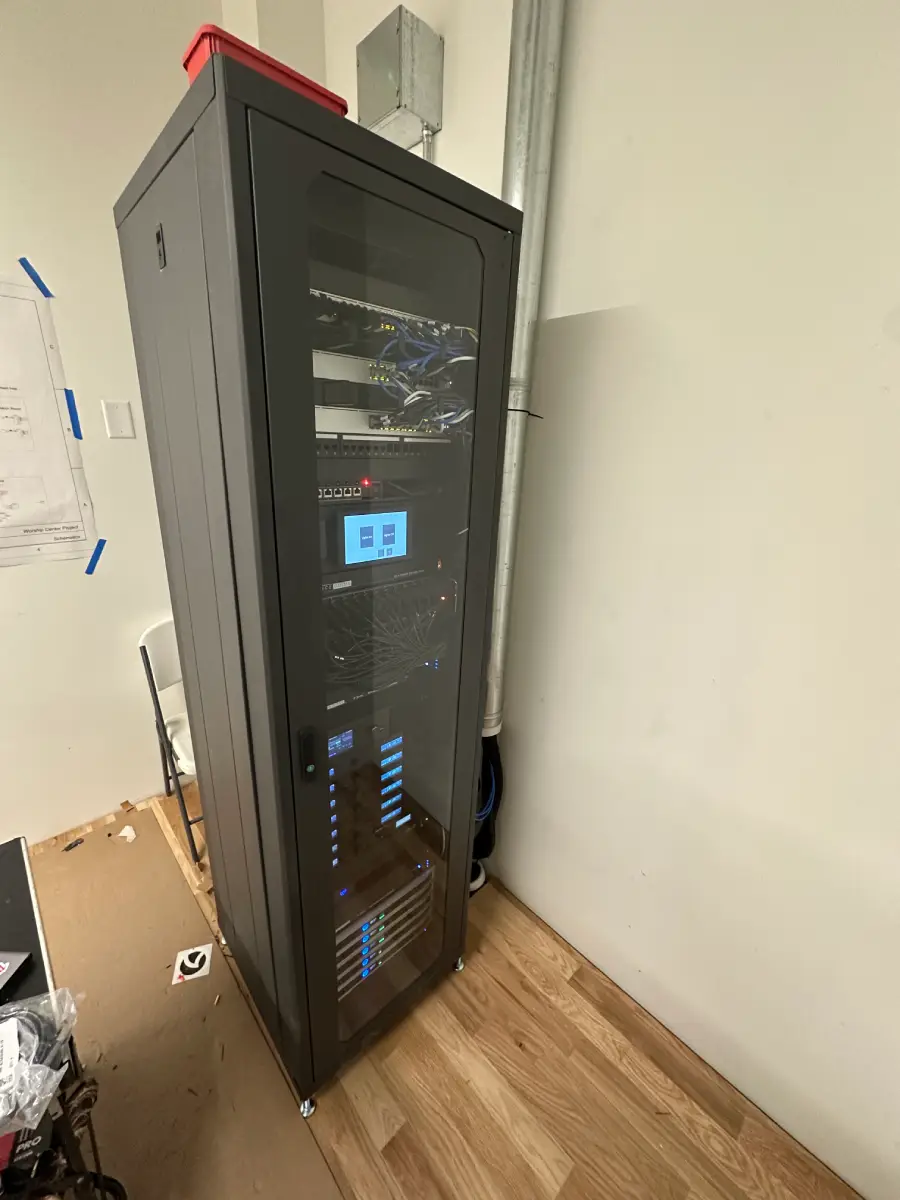 Professional AV equipment rack showing organized infrastructure requiring regular system maintenance and monitoring