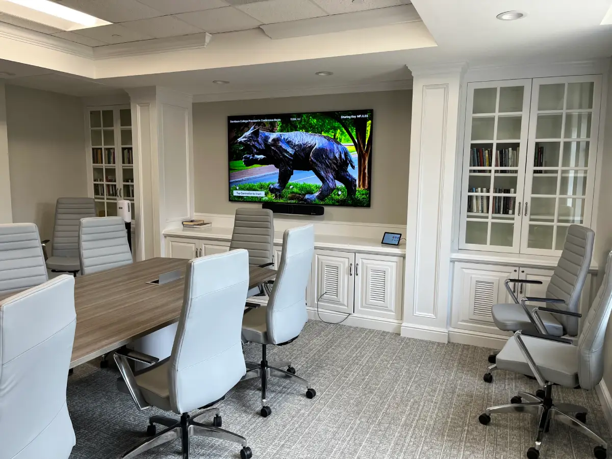 Professional conference room AV installation with wall-mounted display and video conferencing camera by RYGID AV