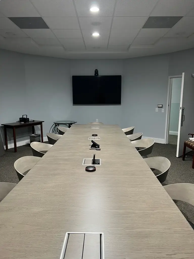 Conference room table with built-in cable management and connection ports for clean AV infrastructure