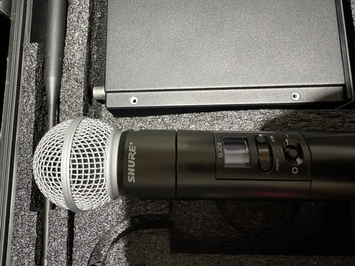 Shure wireless handheld microphone and receiver stored in a professional equipment case