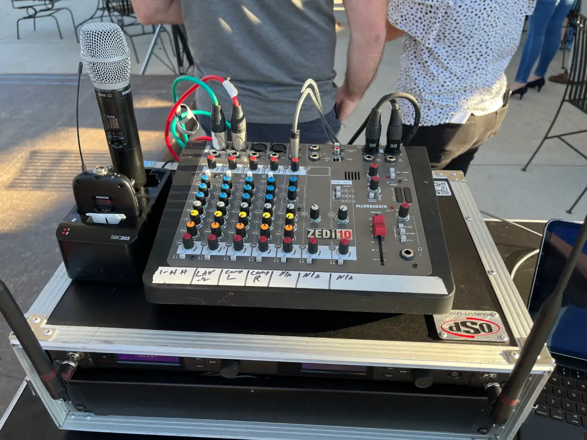Wireless microphone system with mixer and receiver units set up for a live outdoor event