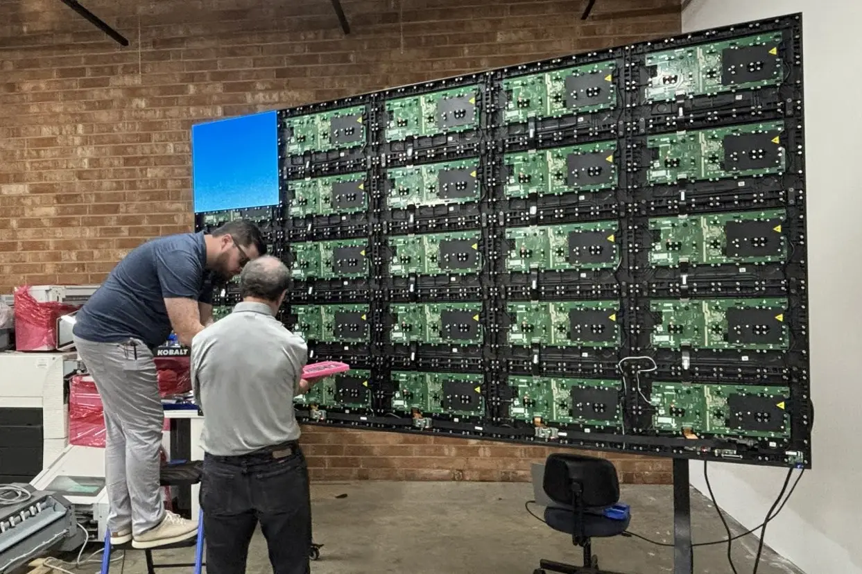 RYGID AV technicians installing direct-view LED wall panels during an on-site build