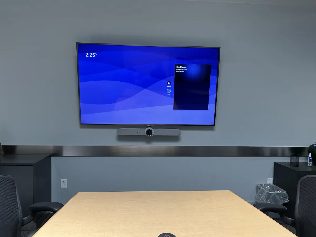 Conference room display showing the day's scheduled meeting with one-touch meeting-start controls
