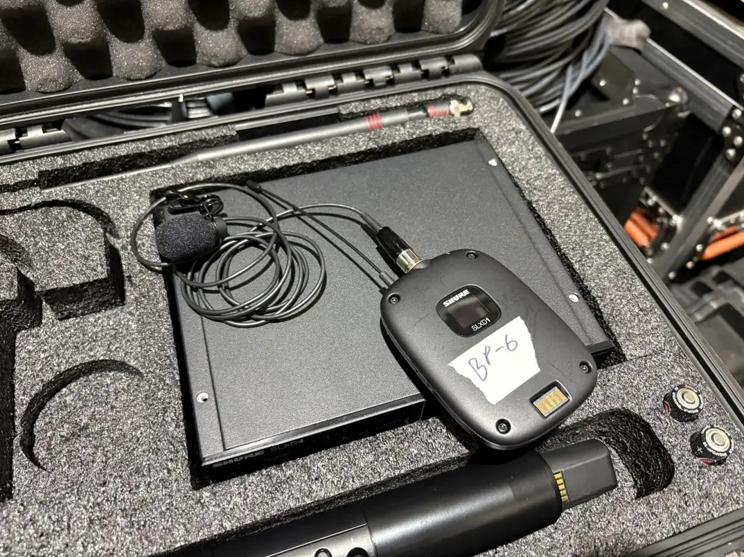 Shure SLXD1 wireless bodypack transmitter connected to a lavalier microphone