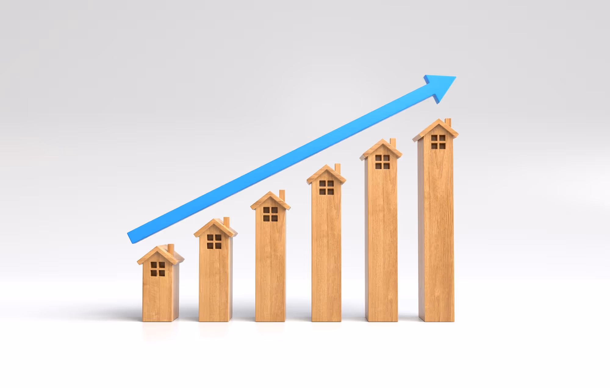3D rendering of a bar chart where the bars are stylized wooden house models of increasing height, topped by a long, diagonal blue arrow pointing upwards, symbolizing rising housing prices or market growth.