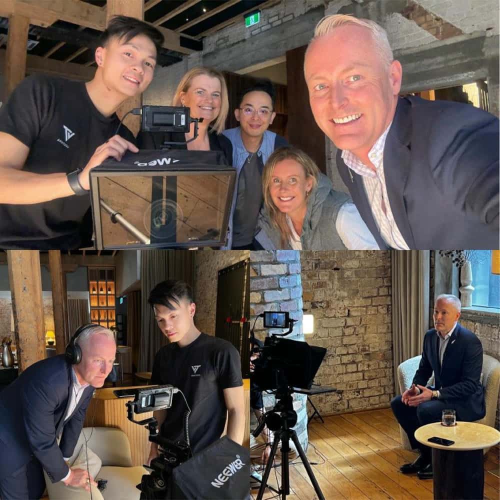 The Vantirra crew filming an interview with Clinton Farley at Hotel Britomart, with a camera on a tripod and the interviewee seated in an armchair
