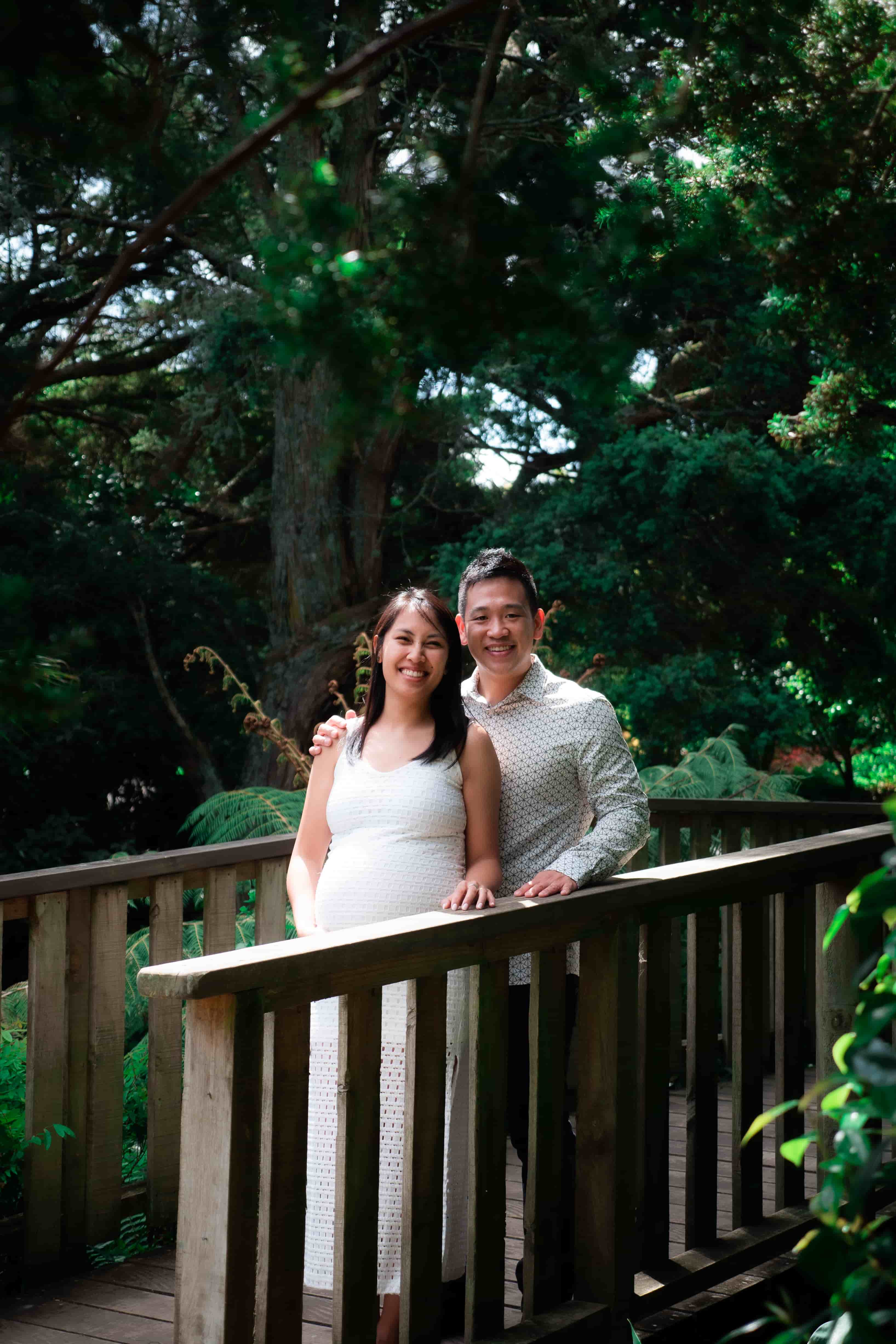 Lucas and Elisa on a wooden bridge framed by native bush