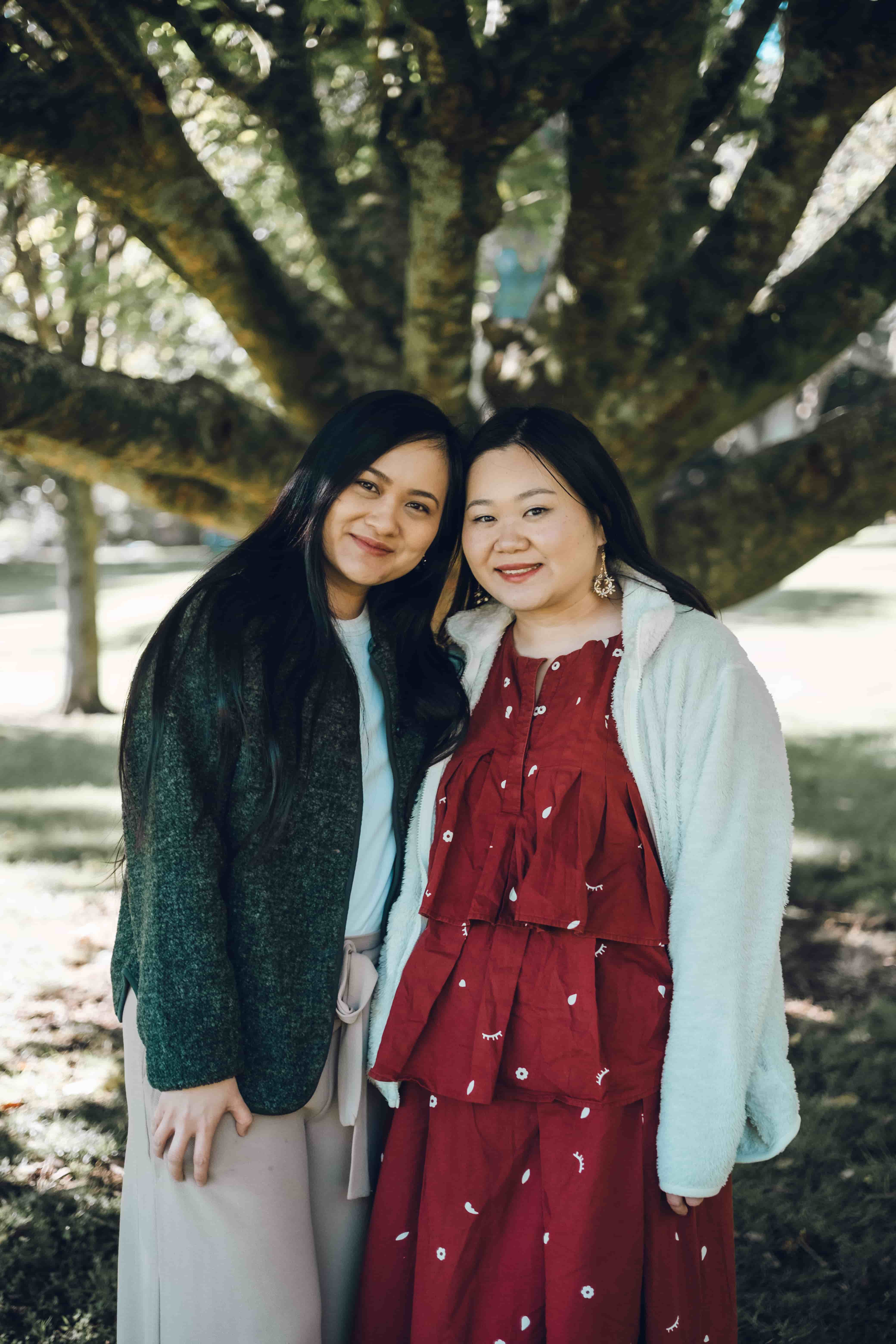 Two sisters cheek to cheek, smiling
